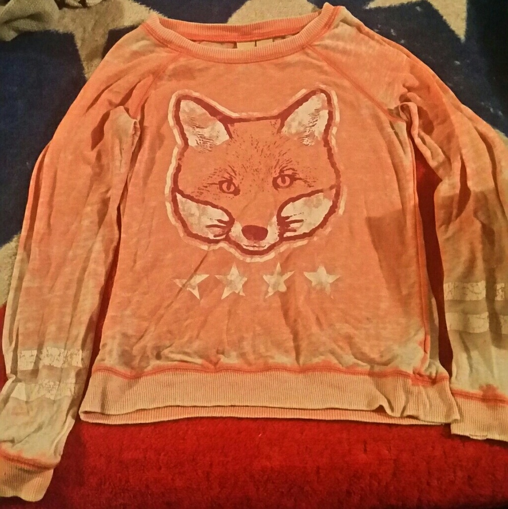 A long sleeve ourangish and peachish colored shirt